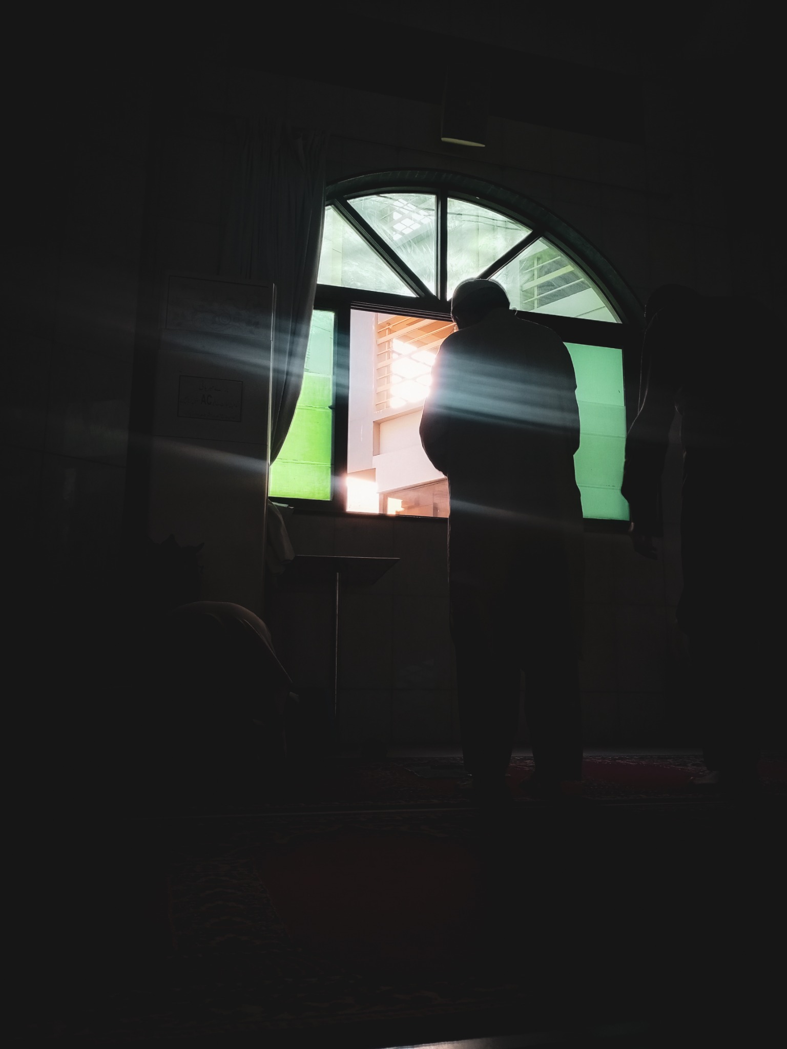 Silhouette in a window-lit interior